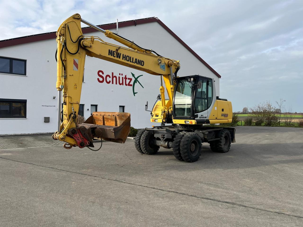 New Holland MH 5.6 inkl. Grabenlöffel, Tieflöffel - Багер на тркала: слика 1 New Holland MH 5.6 inkl. Grabenlöffel, Tieflöffel - Багер на тркала: слика 1