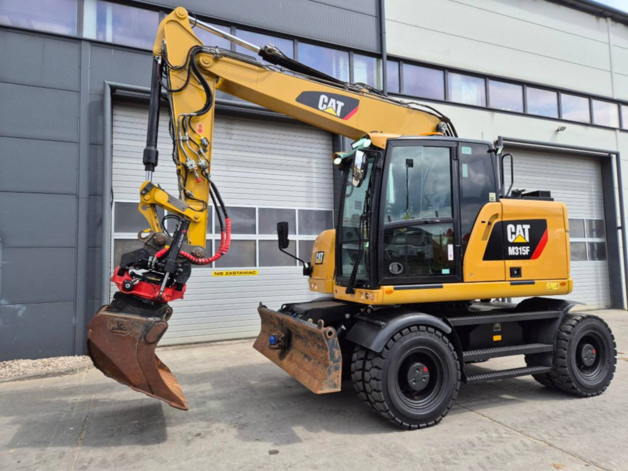 CAT M315F - Багер на тркала: слика 1 CAT M315F - Багер на тркала: слика 1