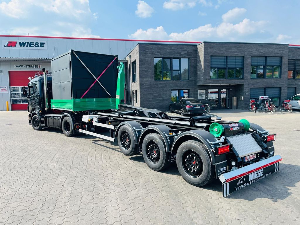 Wiese Hakenliftauflieger Abrollkipper Hooklift - Транспортер на контејнер/ Полуприколка со променливо тело: слика 1 Wiese Hakenliftauflieger Abrollkipper Hooklift - Транспортер на контејнер/ Полуприколка со променливо тело: слика 1