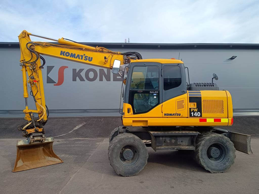 Komatsu PW140-7 PYÖRITTÄJÄLLÄ - Багер на тркала: слика 1 Komatsu PW140-7 PYÖRITTÄJÄLLÄ - Багер на тркала: слика 1