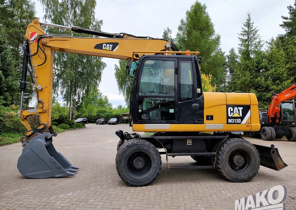 Caterpillar M313D - Багер на тркала: слика 1 Caterpillar M313D - Багер на тркала: слика 1