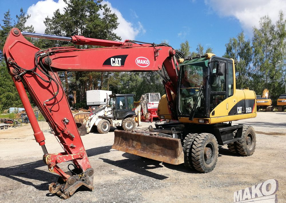 Caterpillar M315 C - Багер на тркала: слика 1 Caterpillar M315 C - Багер на тркала: слика 1