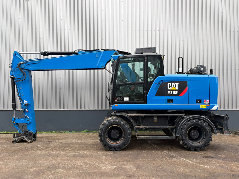 Caterpillar M318F - Багер на тркала: слика 1 Caterpillar M318F - Багер на тркала: слика 1