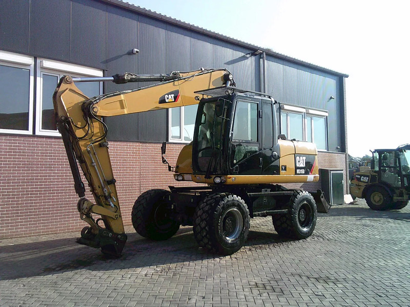 Caterpillar M315D - Багер на тркала: слика 1 Caterpillar M315D - Багер на тркала: слика 1