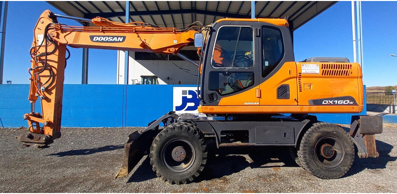Doosan DX140W-3 - Багер на тркала: слика 1 Doosan DX140W-3 - Багер на тркала: слика 1