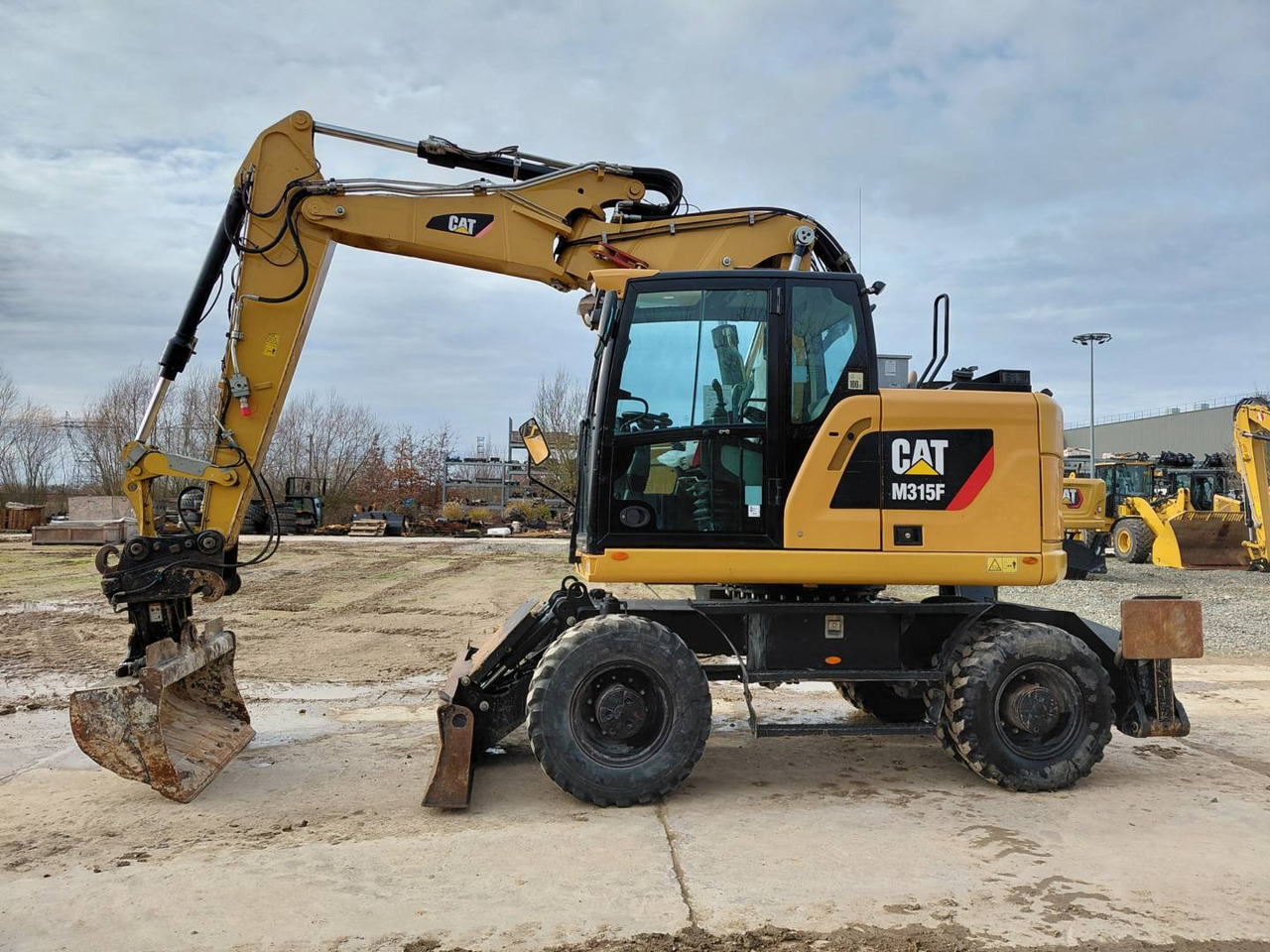 CAT M315F IVC - Багер на тркала: слика 1 CAT M315F IVC - Багер на тркала: слика 1